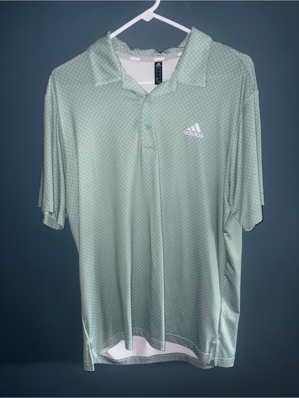 mint green adidas golf polo shirt featuring an all-over geometric diamond patter